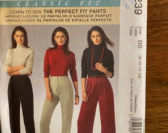 May include: A vintage McCall's sewing pattern for classic fit trousers. The pattern shows three different trouser styles, each paired with a turtleneck top. The pattern's cover includes the text "Learn to Sew The Perfect Fit Pants". The size is BB (8-10-12-14).