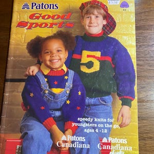 May include: A vintage book cover titled "Patons Good Sports" featuring two children in colorful knit sweaters. The cover includes text that reads "speedy knits for youngsters on the go, ages 4-12." The book is a "Patons Canadiana" publication.