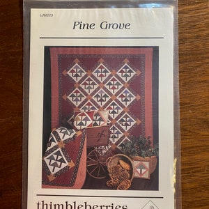 May include: Quilt pattern for a "Pine Grove" quilt featuring a red, white and green colour scheme with a design of pine trees. The pattern is from Thimbleberries, 205 Jefferson St., Hutchinson, MN 55350.