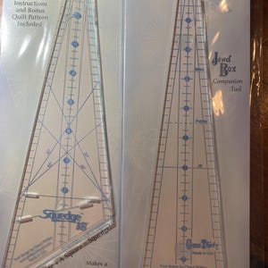 May include: Two clear acrylic quilting rulers in plastic packaging. The left ruler is labelled "Squedge 18" and includes instructions for a quilt pattern. The right ruler is labelled "Jewel Box Gem Thirty". Both rulers are marked with measurements and angles.