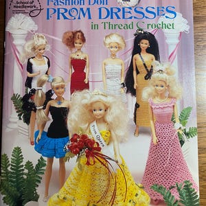 May include: A book cover featuring fashion dolls in thread crochet prom dresses. The cover has the text "Fashion Doll PROM DRESSES in Thread Crochet" and "by Miriam Dow". The dolls are wearing various crochet dresses in colors like yellow, red, and pink.