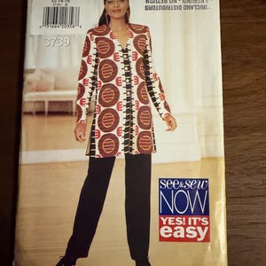 May include: A sewing pattern envelope for a long-sleeved tunic and trousers set, featuring a graphic print of brown and red circles on a white background. The envelope displays the text See & Sew NOW YES! IT'S easy, pattern number 3739, and size 12-14-16.