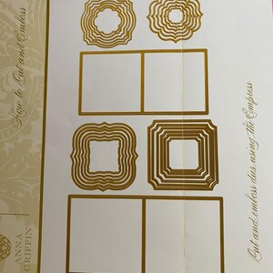 May include: Anna Griffin die cut and emboss set. The set includes various gold-colored, decorative frame dies in different shapes and sizes. The text "How to Cut and Emboss" and "Cut and emboss dies using the Empress" are visible.