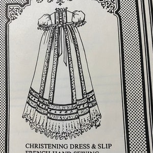 May include: A black and white line drawing of a christening dress and slip for a baby. The dress has a long skirt with ruffles and a bodice with a bow. The text on the image reads "Christening Dress & Slip French Hand Sewing by Machine BHD 403 12"-13""