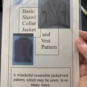 May include: A pattern for a reversible jacket and vest. The pattern is for a shawl collar jacket and a vest that can be sewn in many ways. The text on the pattern says "Basic Shawl Collar Jacket and Vest Pattern. A wonderful reversible jacket/vest pattern, which may be sewn in so many ways. Keep it simple! Keep it fun!"