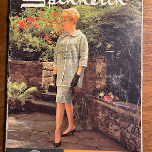 May include: A vintage magazine cover featuring a woman wearing a tweed suit and a white collar. The magazine is called "Spinnerin" and the cover text reads "Versatility Emphasized".