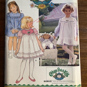 May include: A vintage Butterick sewing pattern featuring Cabbage Patch Kids. The pattern includes illustrations of children's dresses and a doll. The packaging is yellow and green with the Cabbage Patch Kids logo and text.