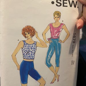 May include: A vintage Kwik Sew sewing pattern, pattern number 1679, featuring illustrations of two women in athletic wear. The pattern includes sizes XS-S-M-L. The design is by Kerstin Martensson.