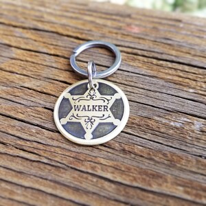 May include: A brass key chain with a sheriff's star design and the name "WALKER" engraved on it.