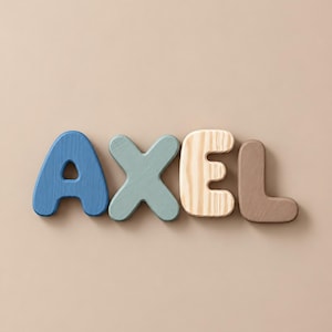 May include: Four individual wooden letters spelling the name AXEL. The letter A is dark blue, the X is sage green, the E features a natural light wood grain finish, and the L is a solid muted brown. Each letter has rounded edges and a smooth surface.