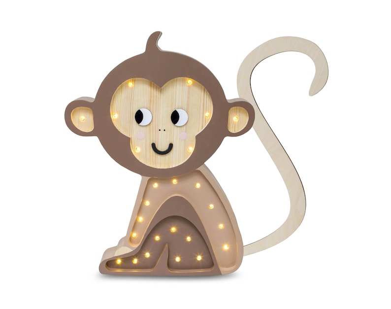 May include: A wooden monkey night light with a brown body and a light brown tail. The monkey has a smiling face with black eyes and a light brown nose. The night light has warm white LED lights that illuminate the monkey's body.