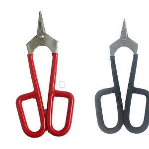 May include: Two pairs of metal shears with different colored handles. One pair has red handles and the other has black handles.
