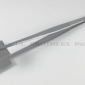 May include: Silver tweezers with a flat, rectangular metal plate attached to the end. The tweezers are designed for holding and manipulating small objects.