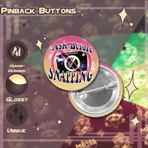 May include: Round pinback button with a pink, orange, and blue design. The button features a camera with a prohibition symbol and the text "Ask Before Snapping". The button is glossy and unique.