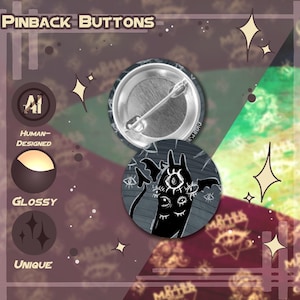 May include: Pinback buttons with a dark, gothic theme. One button shows the back with a pin, the other features a black and white illustration of a creature with multiple eyes and bat-like wings. The background has text that says "Pinback Buttons".