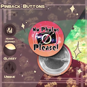 May include: Pinback button with a red and orange gradient background, featuring a black camera with a galaxy design and the text "No Photos Please!". The button has a glossy finish and a metal pin backing. The design is unique and human-designed.