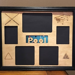 May include: A black picture frame with a wood interior. The frame has eight openings for photos. The openings are arranged in a grid pattern. The top opening shows a pool table. The middle opening shows a pool table with the word "Pool" written below it. The bottom opening shows a triangle of pool balls. The frame is perfect for displaying photos of your favorite pool games.