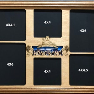 May include: A wooden picture frame with a Hong Kong theme. The frame has seven openings for photos, with sizes labeled 4x4, 4x4.5, and 4x6 inches. The frame features a laser-cut design of the Hong Kong skyline and a statue of Buddha.