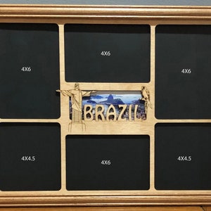 May include: A wooden picture frame with seven openings for photos. The frame is light brown and has a black mat. The openings are labeled with the sizes of the photos they can hold. The frame has a decorative cutout of the Christ the Redeemer statue, a bird, and the word "BRAZIL" in the center.