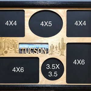 May include: A wooden picture frame with a black border and a desert theme. The frame has seven openings for photos, including a 4x5 oval opening, two 4x4 square openings, three 4x6 rectangular openings, and one 3.5x3.5 oval opening. The frame also features a small rectangular opening with a photo of a desert scene and the word "TUCSON" in cutout letters.