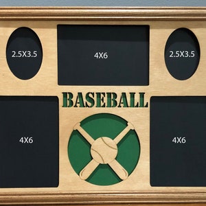 May include: A wooden picture frame with a baseball theme. It has five openings for photos, two are 2.5x3.5 inches and three are 4x6 inches. The frame has a green background with a baseball and two crossed bats.