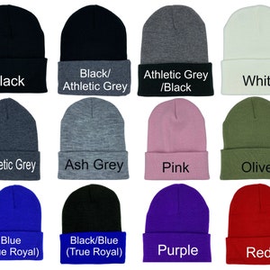 May include: Twelve different color beanie hats. The hats are all the same style, with a fold-over cuff. The colors are black, athletic grey, white, ash grey, pink, olive, blue, black/blue, purple, and red.