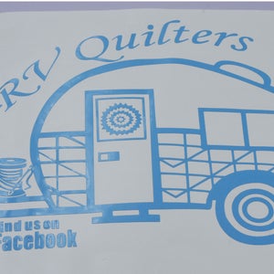 May include: A blue and white decal of a camper van with the text "RV Quilters" above it and "Find us on Facebook" below it.