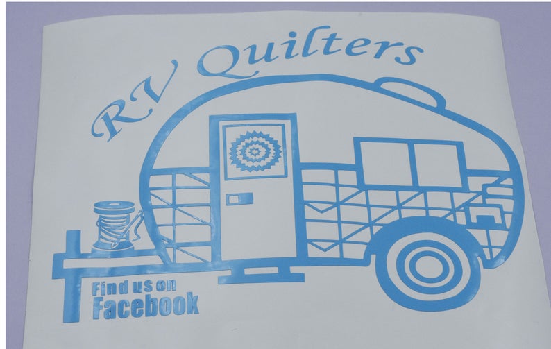 May include: A blue and white decal of a camper van with the text "RV Quilters" above it and "Find us on Facebook" below it.