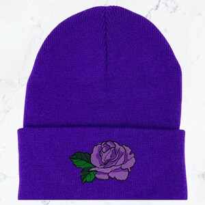 May include: Purple beanie with a purple rose embroidered on the front.