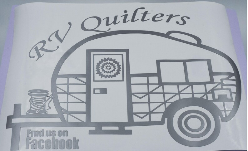 May include: Black and white illustration of an RV with the text "RV Quilters" above it. The RV has a door, a window, and a patterned design. The text "Find us on Facebook" is below the RV.