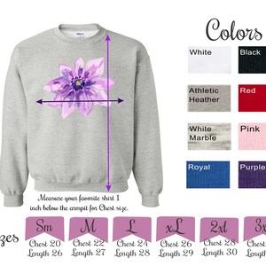 May include: A gray sweatshirt with a purple flower design. The sweatshirt is available in sizes small, medium, large, extra large, 2XL, and 3XL. The sweatshirt is available in 10 colors: white, black, athletic heather, red, white marble, pink, royal, purple, navy, and teal. The text "Colors" and "Sizes" are printed on the image.