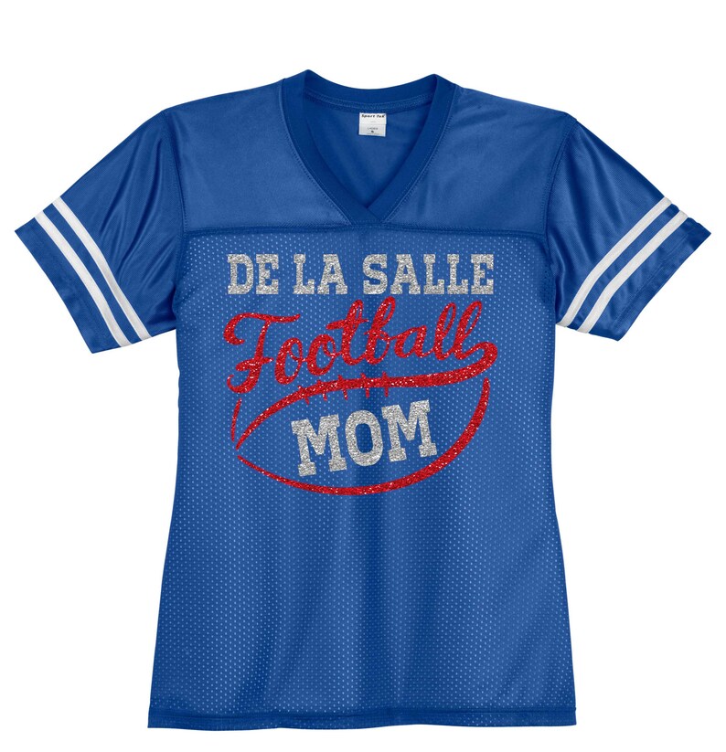May include: Blue and white football jersey with the text "DE LA SALLE Football MOM" in silver glitter and red lettering.