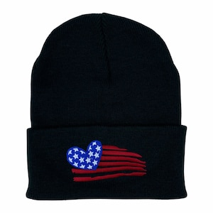 May include: Black beanie with a red, white, and blue heart-shaped American flag design.