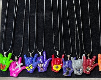 ILY handshape w/charm necklaces