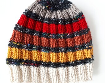 May include: A striped knit hat with a white brim. The hat is made with a variety of colors, including red, orange, yellow, and black.