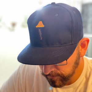 A Christmas Story Leg Lamp hat cap. Vintage look and feel. High crown SnapBack. Stitched leg lamp logo