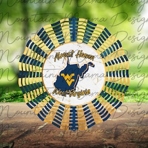 May include: A metal wind spinner with a blue and gold design. The center of the spinner features a white circle with a map of West Virginia and the text "Almost Heaven West Virginia".