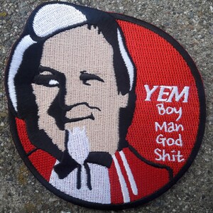 May include: A red, white, and black embroidered patch with a cartoon image of a man with a white beard and the text "YEM Boy Man God Shit".
