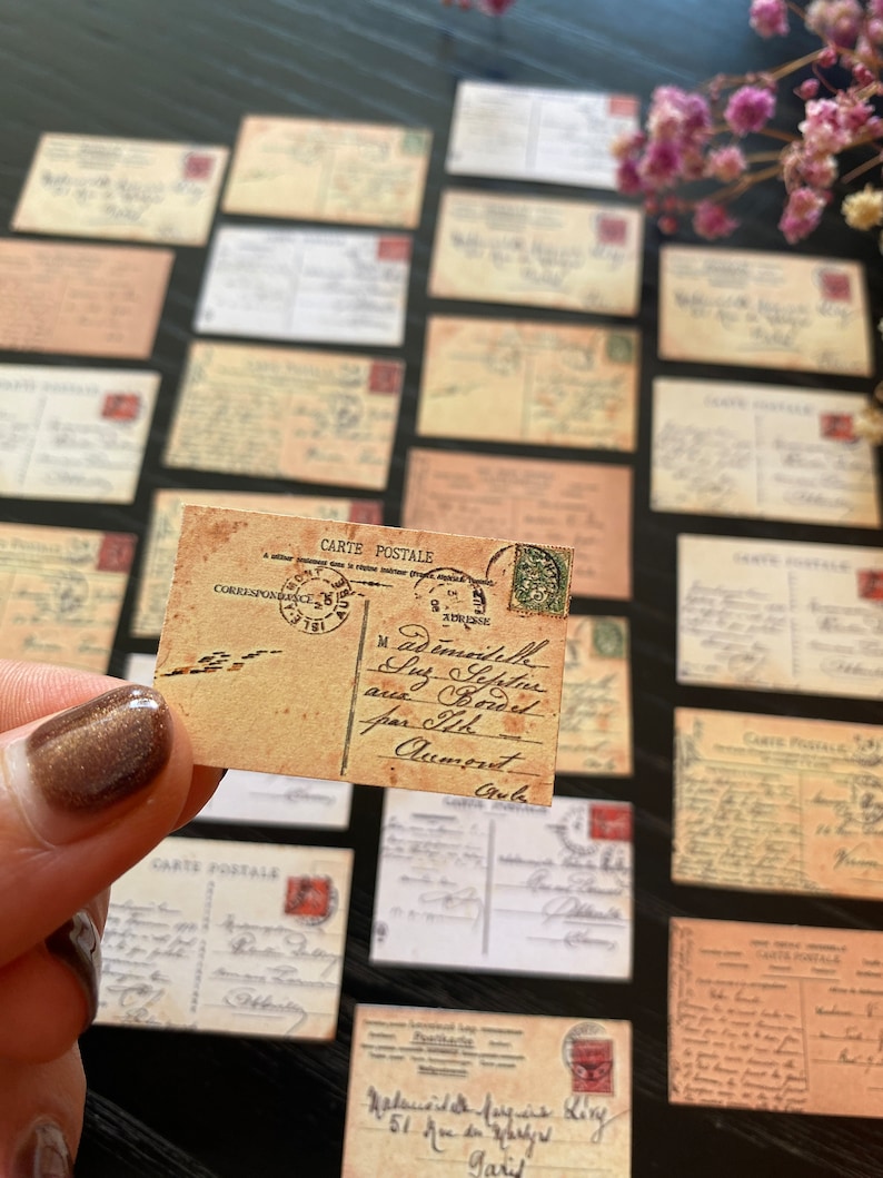 May include: A collection of vintage postcards with handwritten messages and stamps. The postcards are in various shades of brown and cream, with some featuring faded ink and worn edges. The text on the postcards includes the words "CARTE POSTALE" and "CORRESPONDANCE".