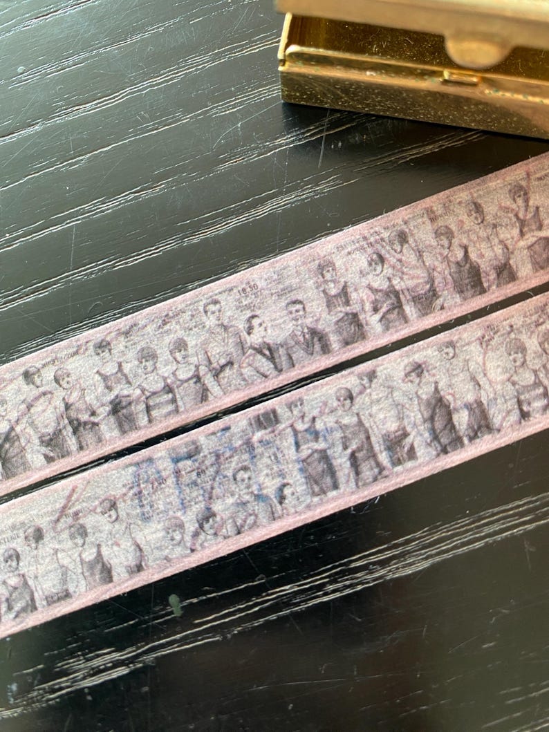 May include: Two rolls of pink washi tape featuring a vintage black and white image of people in a line. The tape has a subtle pink border.