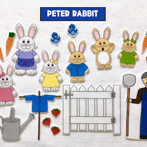 May include: A felt set of cutouts for a Peter Rabbit themed story time. The set includes a bluebird, a white picket fence, a scarecrow, a watering can, carrots, strawberries, and several bunnies. The bunnies are wearing different coloured clothes. The text "PETER RABBIT" is printed in blue on a white rectangle.
