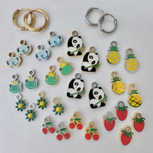 May include: Assortment of colorful enamel charms featuring animals, fruit, and other designs. The charms are made of metal and have a shiny finish. They are perfect for adding a touch of personality to jewelry, bags, or keychains.