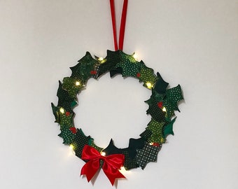Fabric holly leaves wreath with LED lights. Christmas indoor handmade wreath