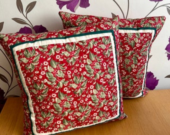 A pair of Christmas cushions in red and green festive holly floral fabric NEW-NOV