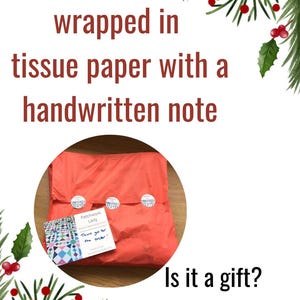 May include: A red tissue paper package with a handwritten note that says "Thank you for the order!"  The package is sealed with white stickers. The text "Is it a gift? I can send directly to recipient" is written below the package.