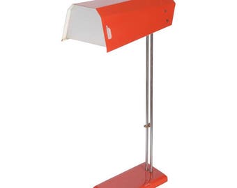 May include: A red and white desk lamp with a long, adjustable arm and a rectangular base. The lamp has a white shade and a chrome finish.
