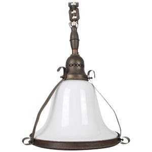 May include: A vintage brass pendant light with a white glass shade. The shade is bell-shaped and has a metal rim. The light fixture has a chain and a decorative metal top.
