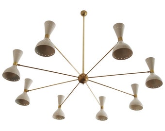 May include: A brass and white eight-light chandelier with a starburst design. The chandelier has a central stem with six arms extending out, each with a white, cone-shaped shade.