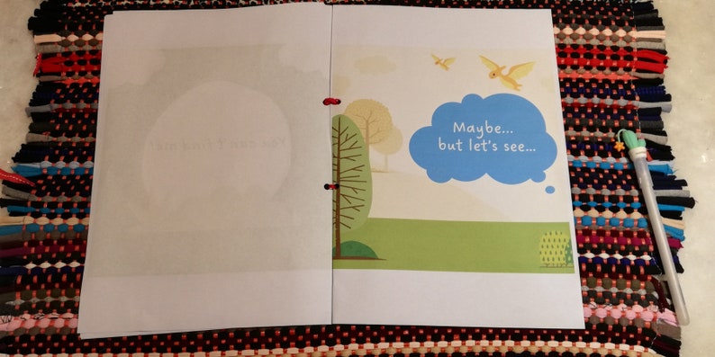 May include: An open book with a white background and a colorful illustration on the right page. The illustration features a green tree, a blue cloud with the text "Maybe... but let's see..." and two yellow birds flying in the sky.