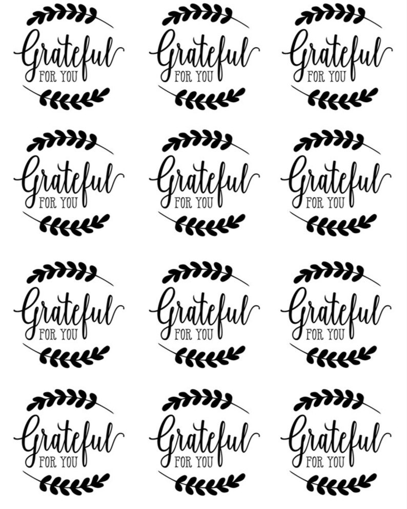 May include: Twelve black and white printable gift tags with the text "Grateful for you" and a wreath of leaves around the text.